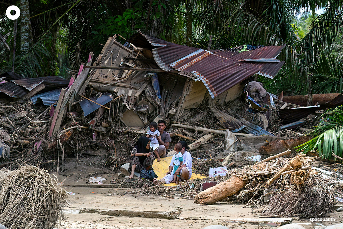 PhotoStory-   ชาวบ้านนั่งอยู่หน้าบ้านเรือนที่เสียหายจากน้ำท่วมฉับพลันในหมู่บ้านเอก กาโรกา จังหวัดสุมาตราเหนือ อินโดนีเซีย เมื่อวันที่ 4 ธันวาคม 2025 (Photo by YT HARIONO / AFP) 